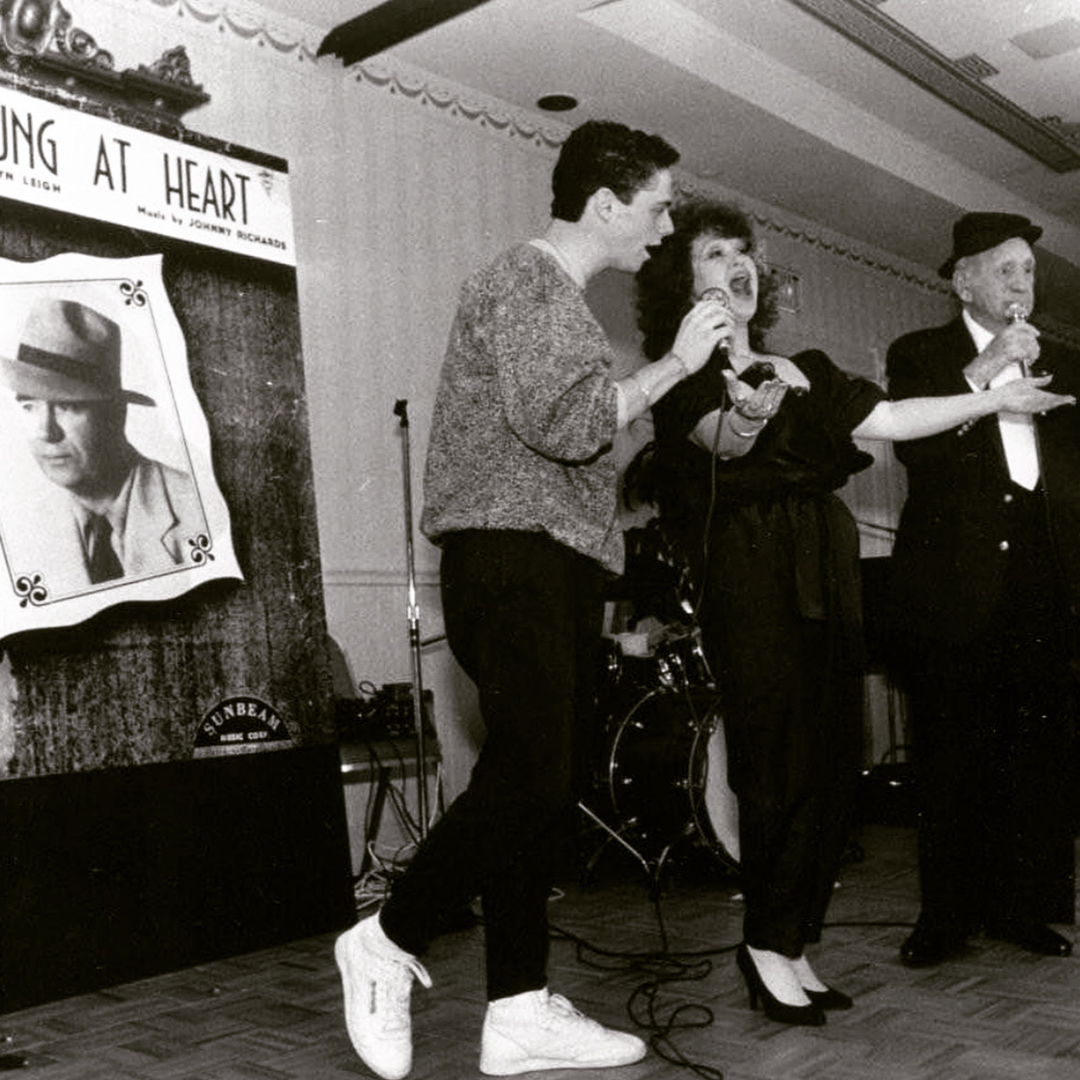 Rob Johnston performing on stage at a Young at Heart event